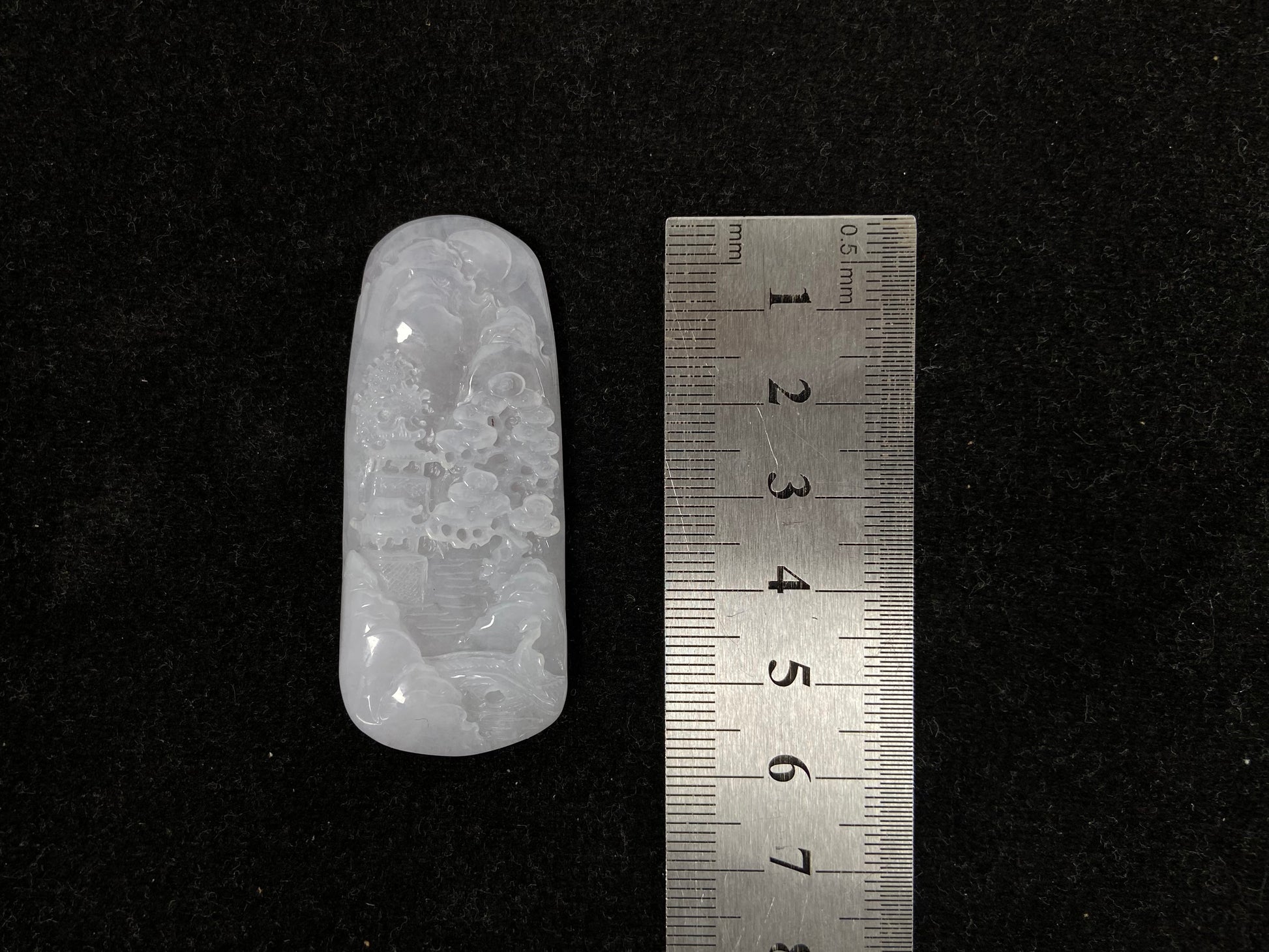 A icy white jadeite landscape plaque.