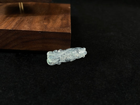 A white translucent jade koi carving.
