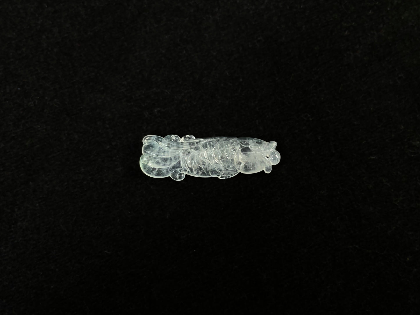 A white translucent jade koi carving.