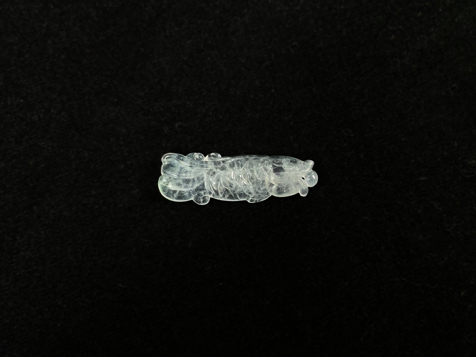 A white translucent jade koi carving.