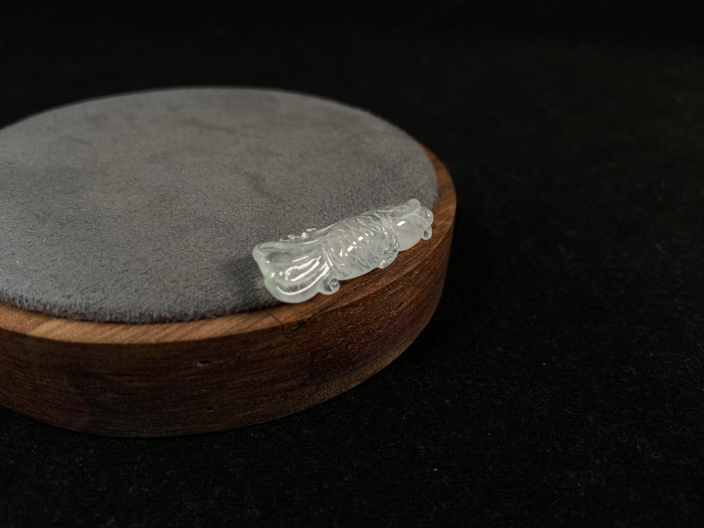 A white translucent jade koi carving.