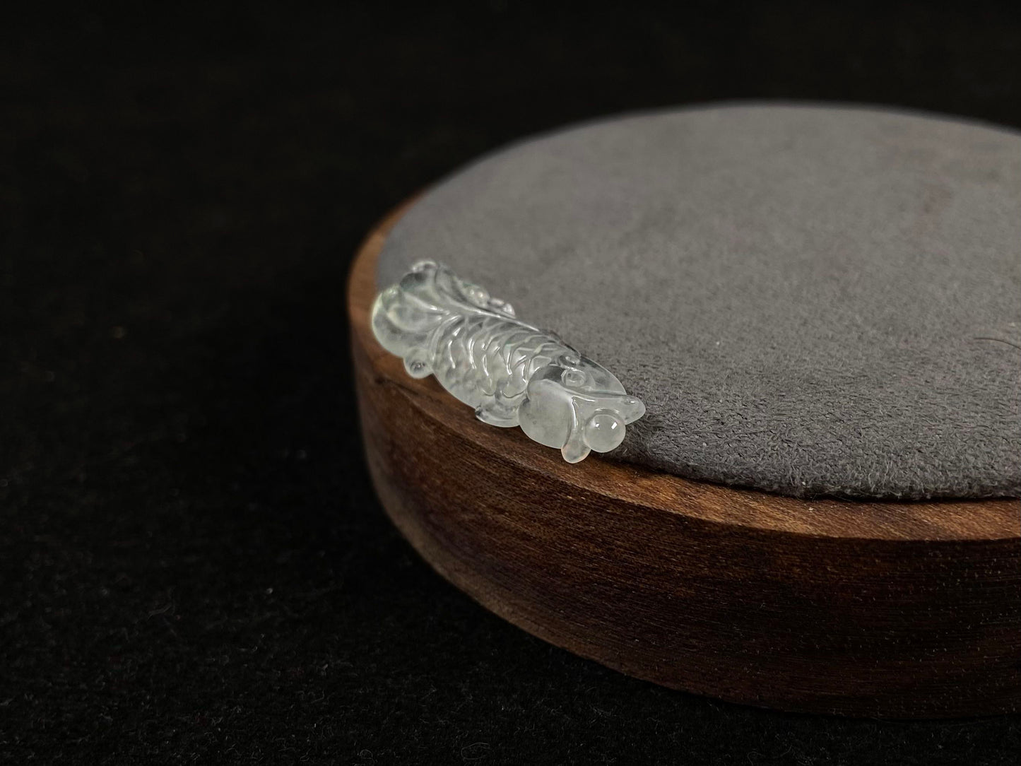 A white translucent jade koi carving.