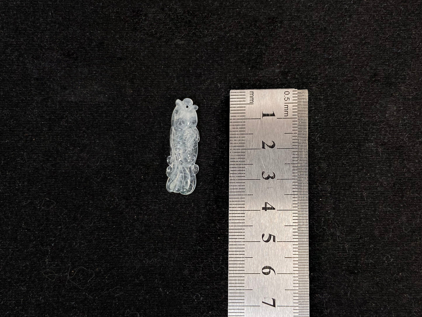 A white translucent jade koi carving.