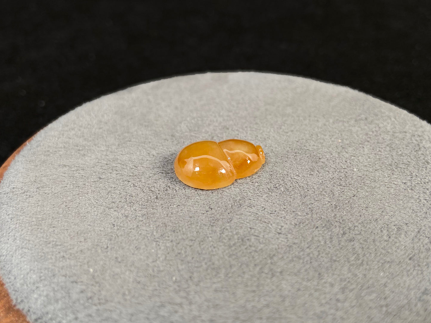 An amber jade stone featuring a calabash motif.