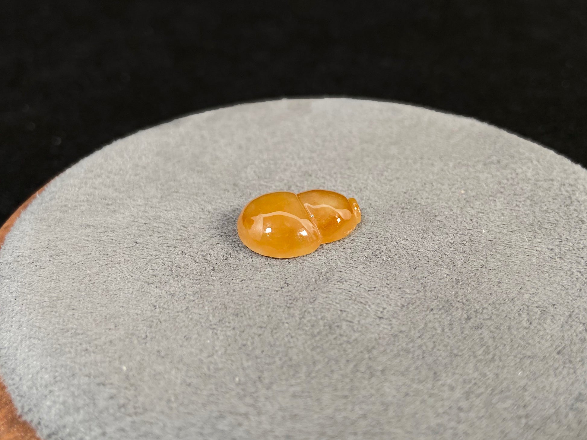 An amber jade stone featuring a calabash motif.