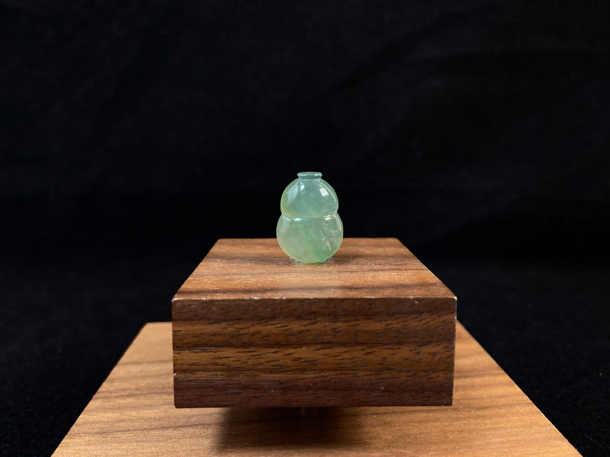 This transparent pale green jade is carved in calabash form.