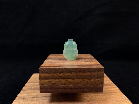 This transparent pale green jade is carved in calabash form.