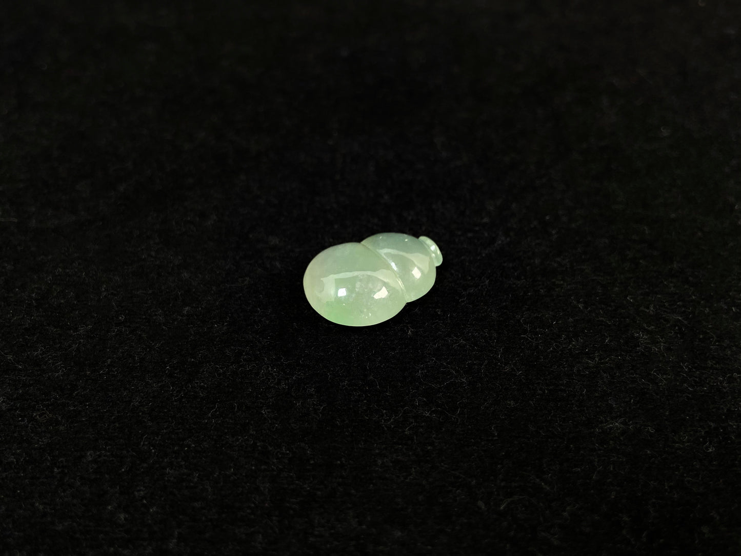 This transparent pale green jade is carved in calabash form.