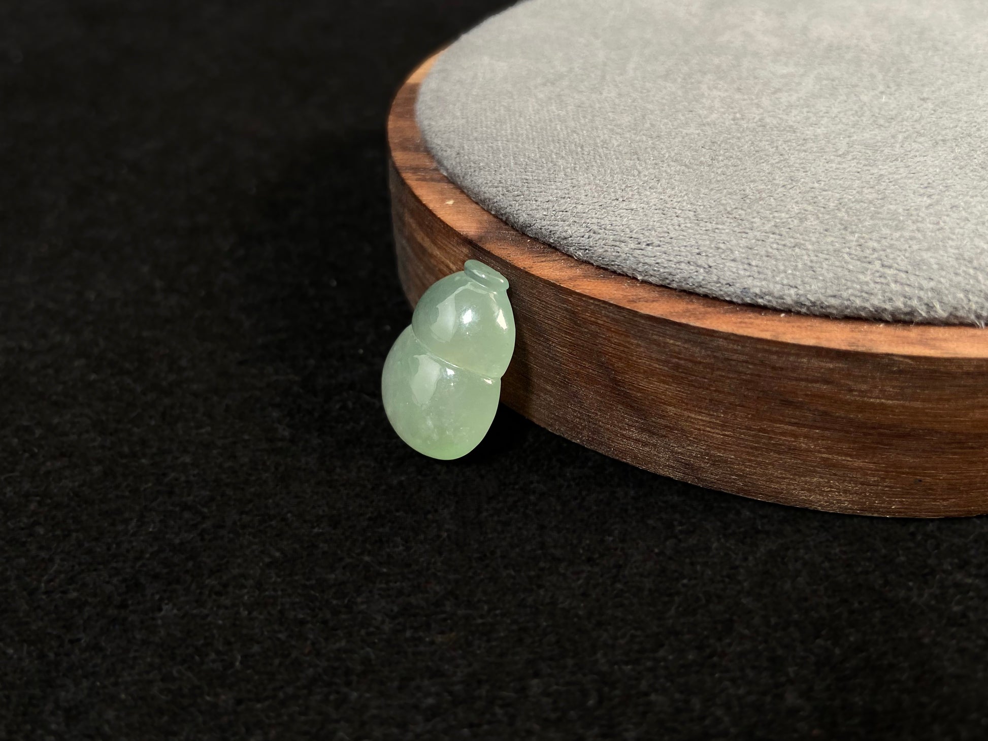 This transparent pale green jade is carved in calabash form.