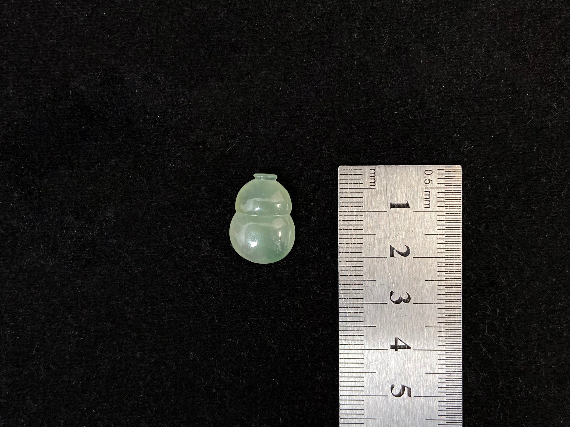 This transparent pale green jade is carved in calabash form.