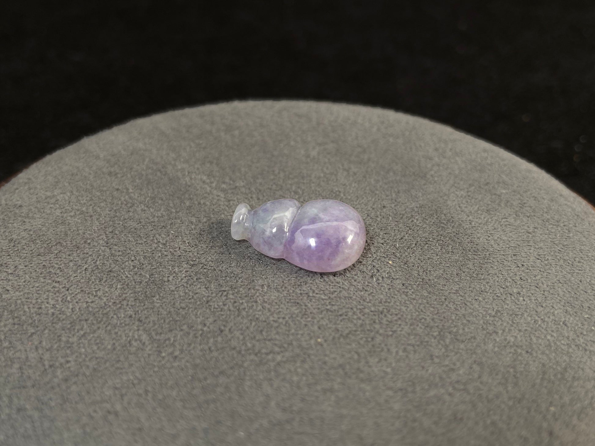 This lavender jade is carved into a semi calabash shape.