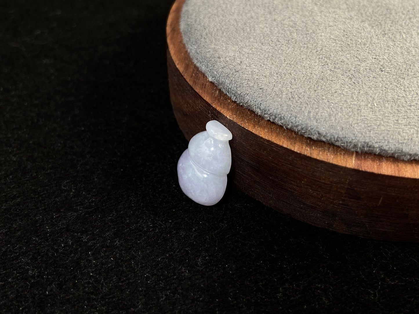 This lavender jade is carved into a semi calabash shape.