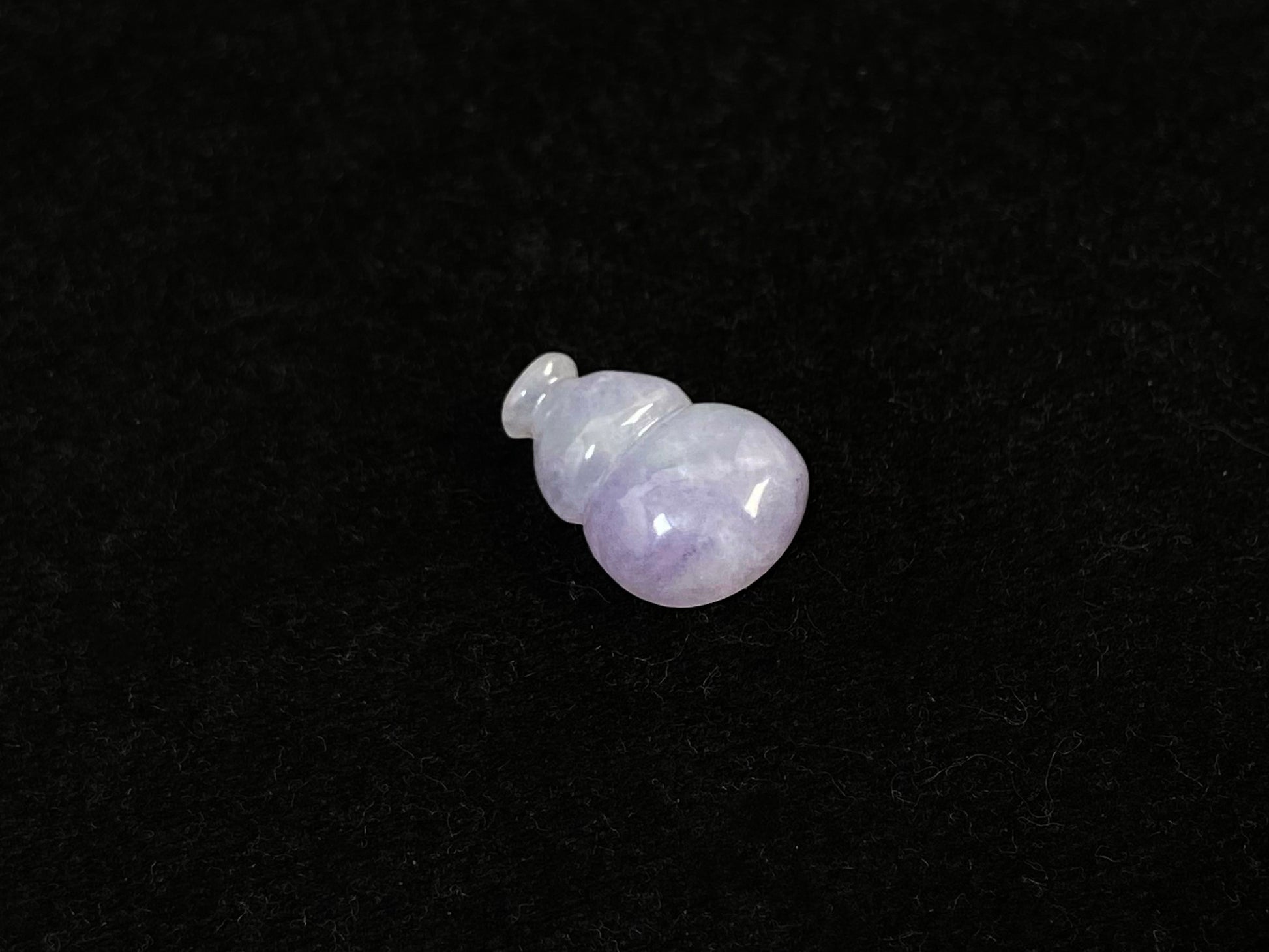 This lavender jade is carved into a semi calabash shape.