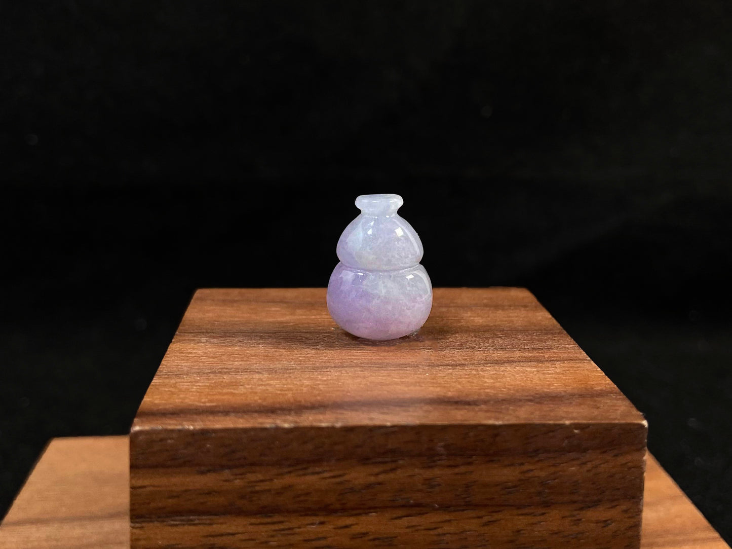 This lavender jade is carved into a semi calabash shape.