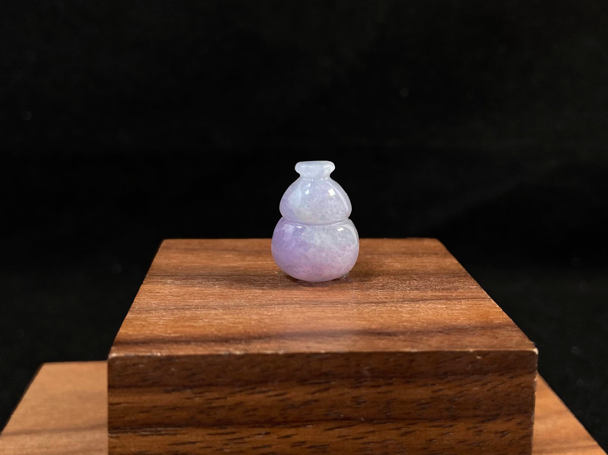 This lavender jade is carved into a semi calabash shape.