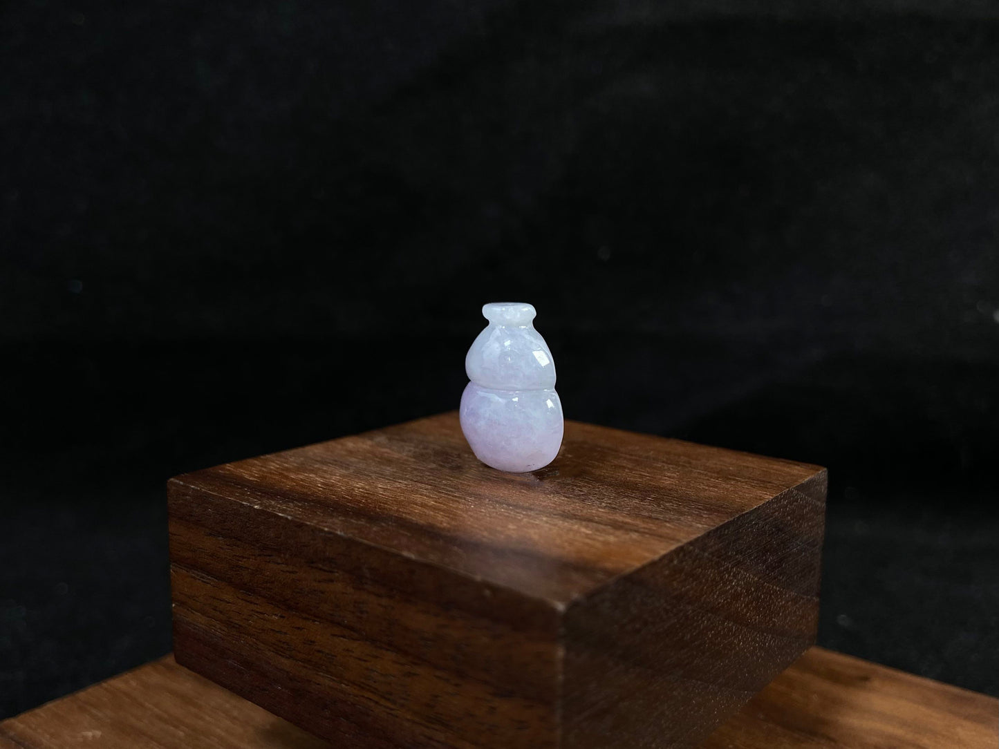 This lavender jade is carved into a semi calabash shape.