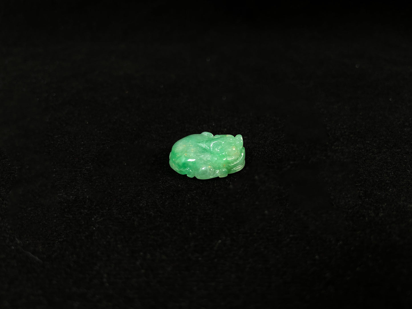 A green jade Pixiu carving.