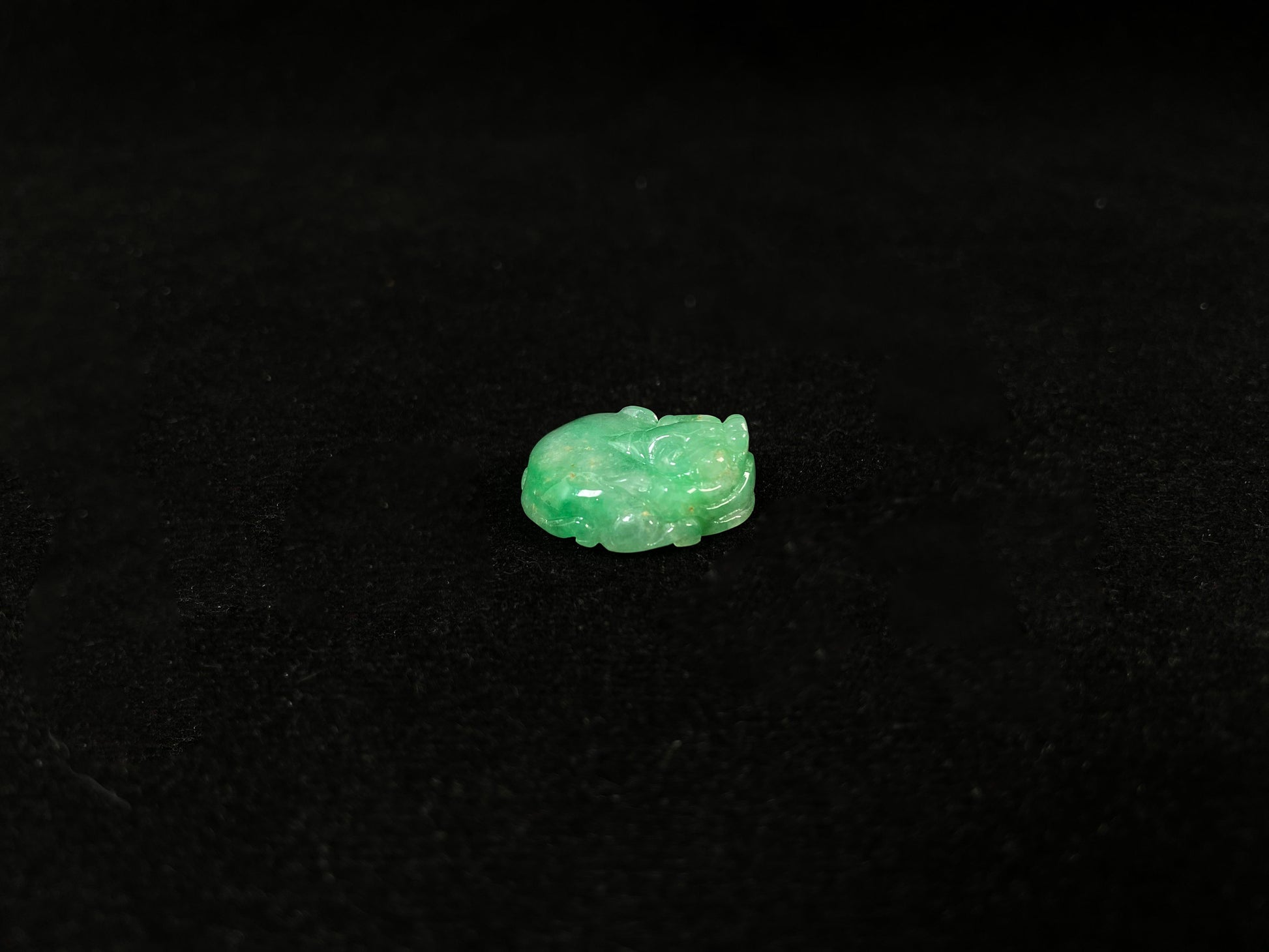 A green jade Pixiu carving.