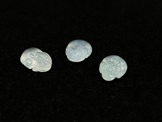 Three front-facing Pixiu carvings in icy jadeite.