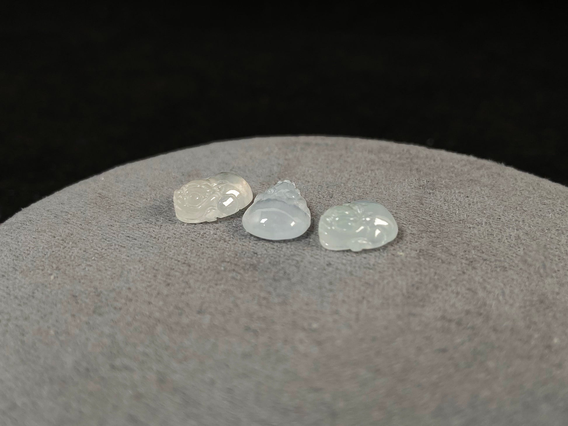 Three front-facing Pixiu carvings in icy jadeite.