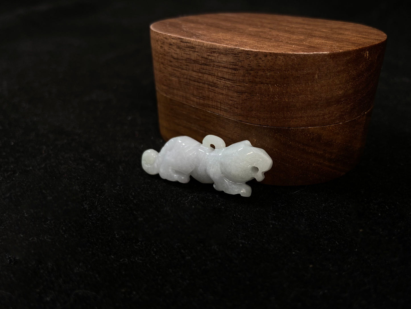 A pale green jade tiger with subtle lavender undertones.