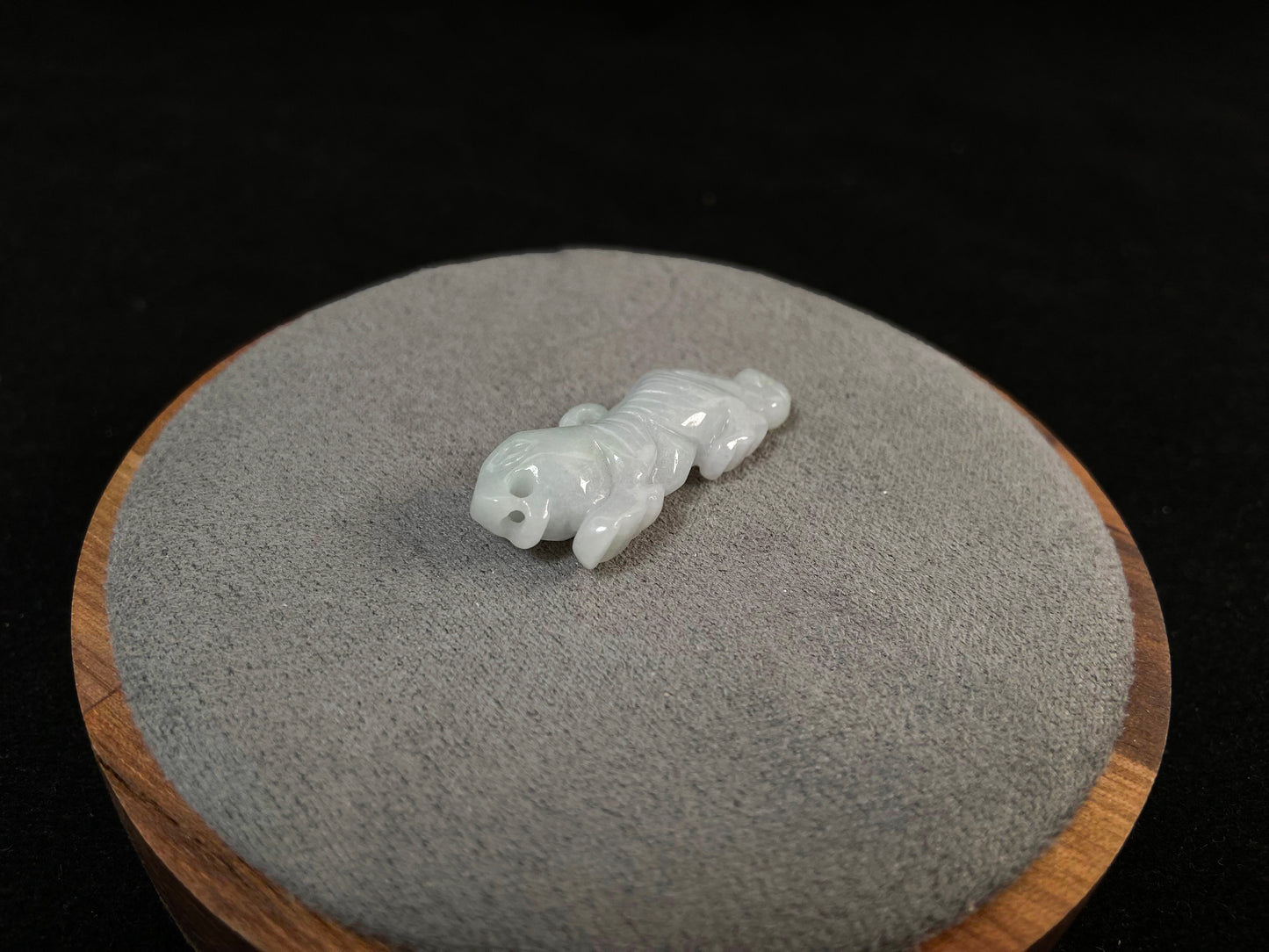 A pale green jade tiger with subtle lavender undertones.