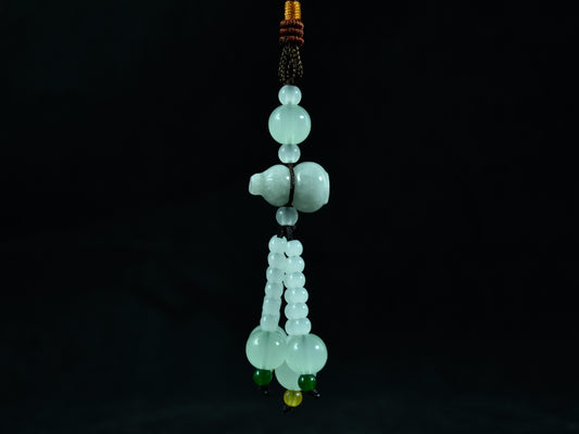 Green jade bead necklace on a black background