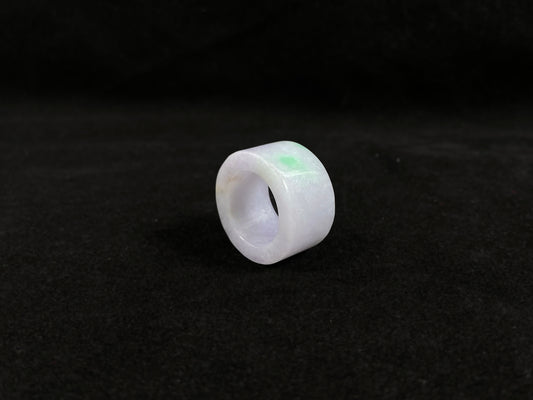 This creamy white jadeite thumb ring features elegant green veining.