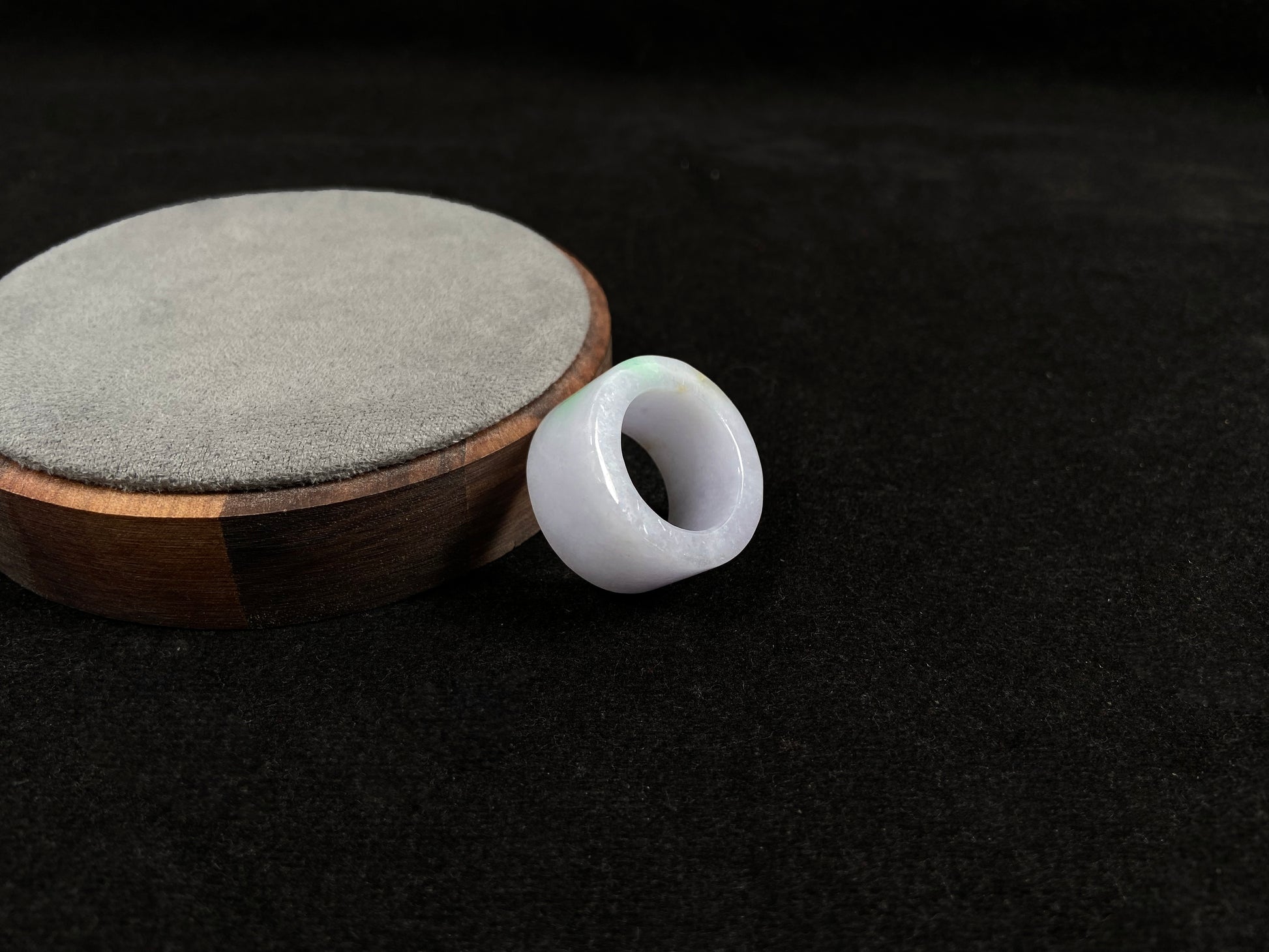 This creamy white jadeite thumb ring features elegant green veining.