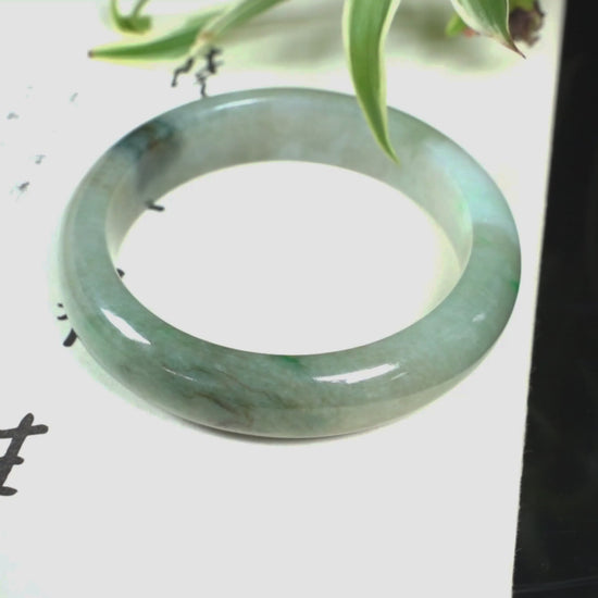 A soft greenish-aqua with natural veins  jadeite bangle.