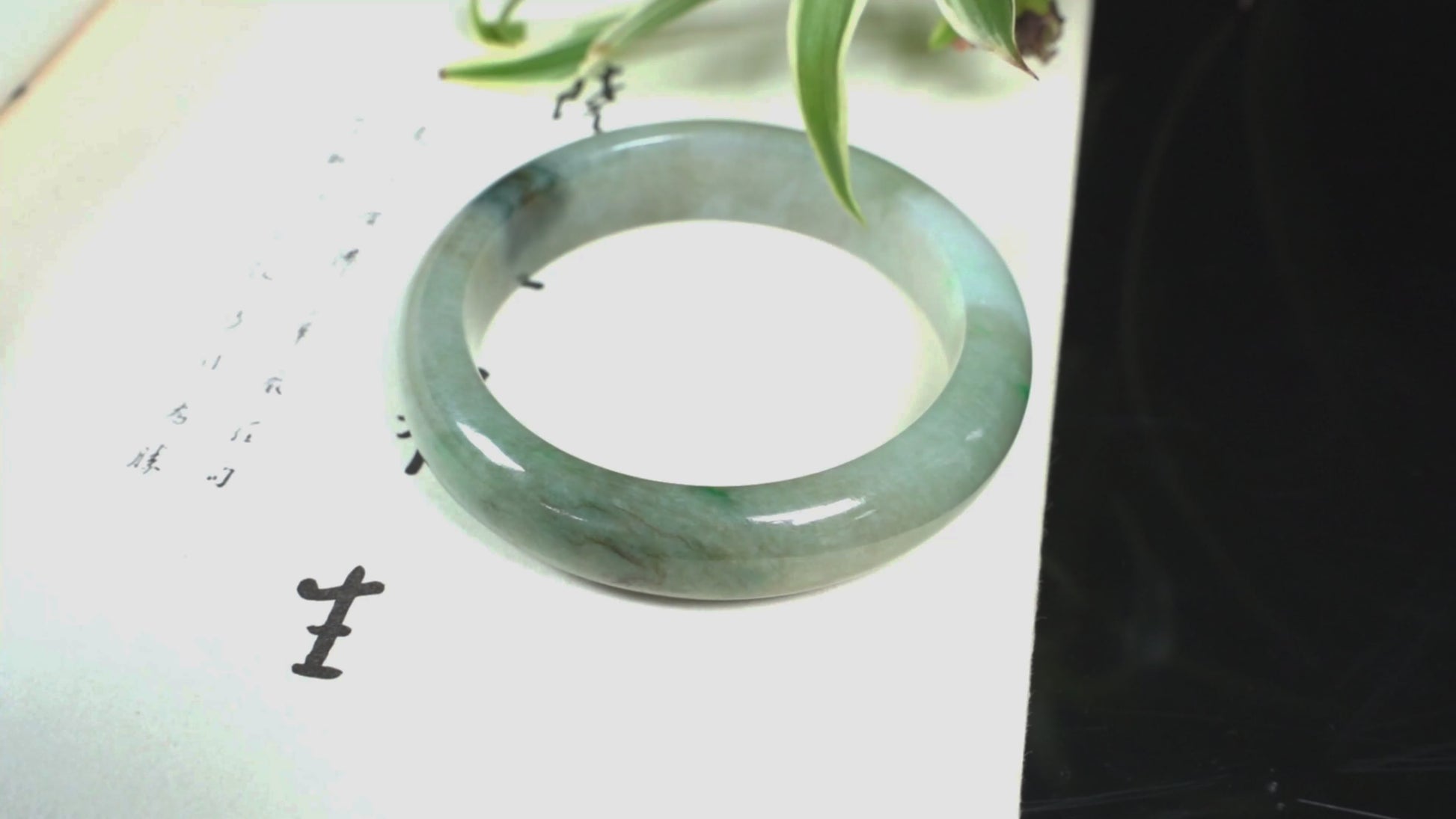 A soft greenish-aqua with natural veins  jadeite bangle.