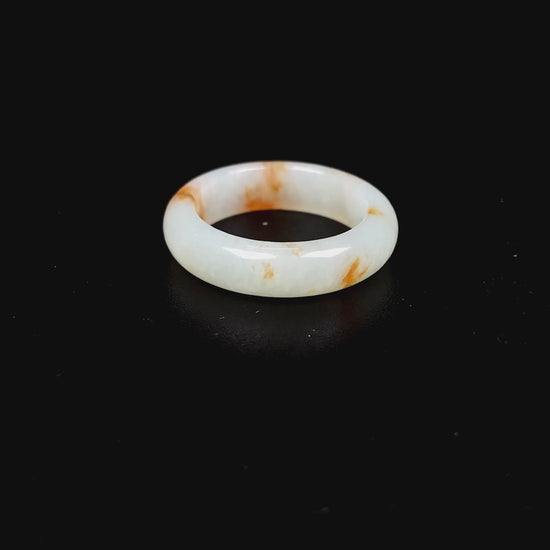 A misty white with amber fleck jadeite ring.