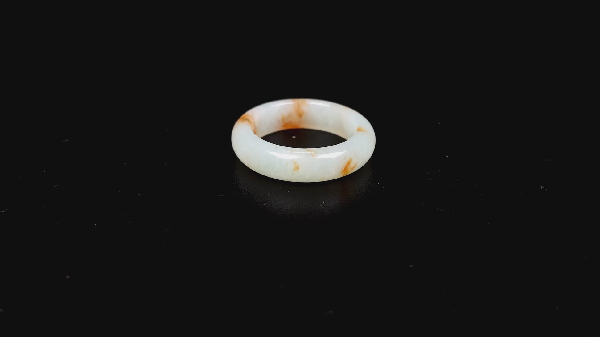 A misty white with amber fleck jadeite ring.