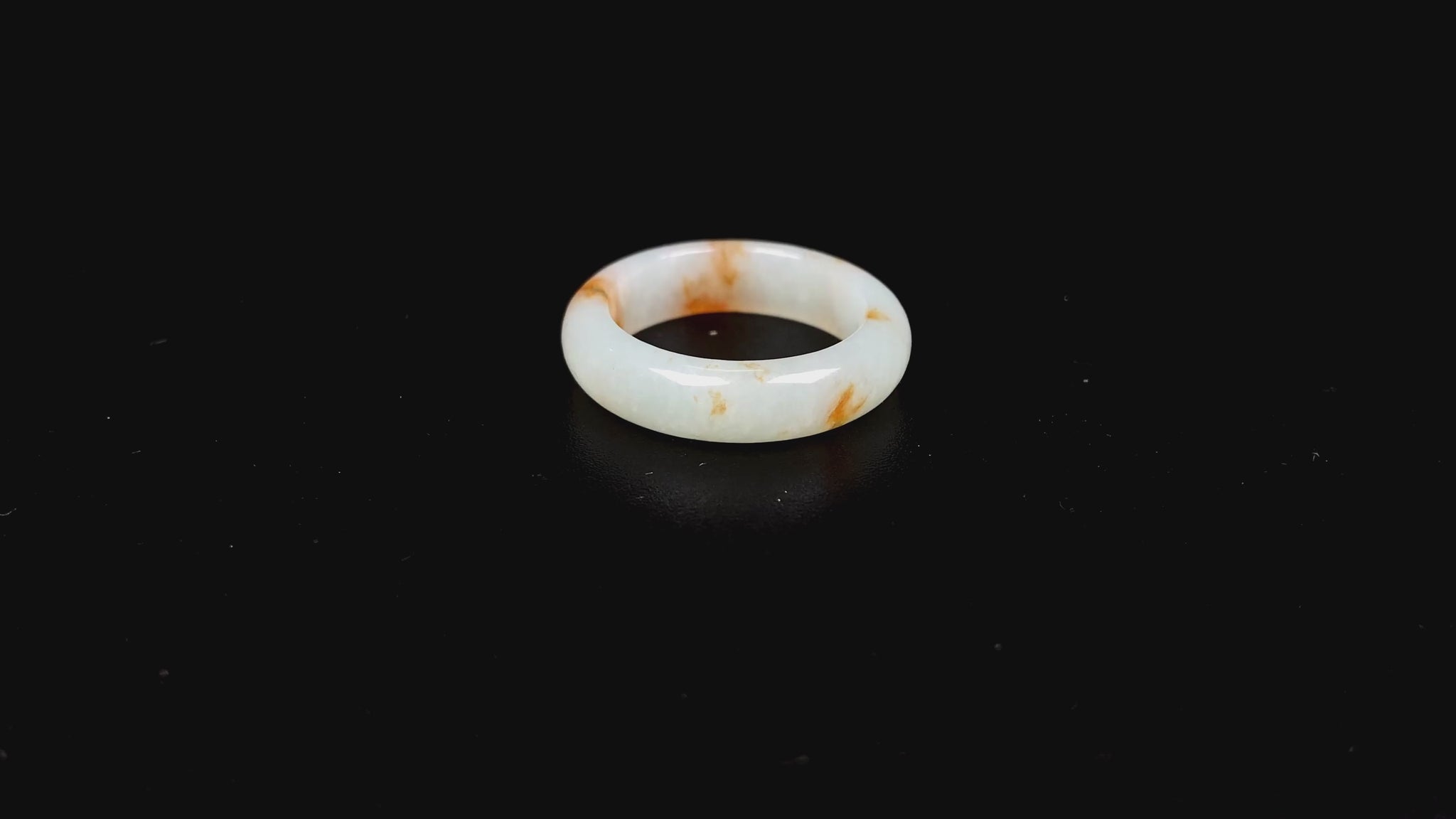 A misty white with amber fleck jadeite ring.