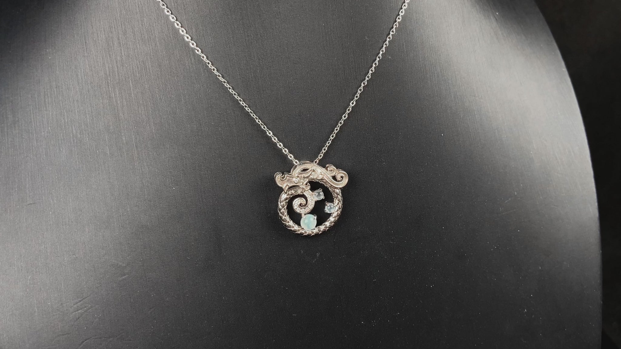 A icy blue coiled dragon jadeite pendant.