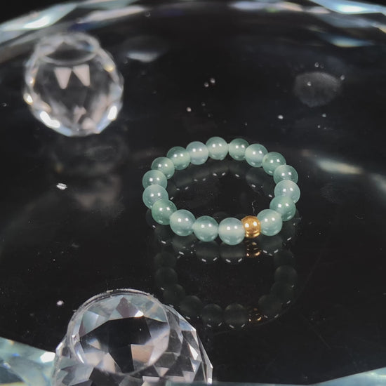 A gold center glacier blue jadeite ring.