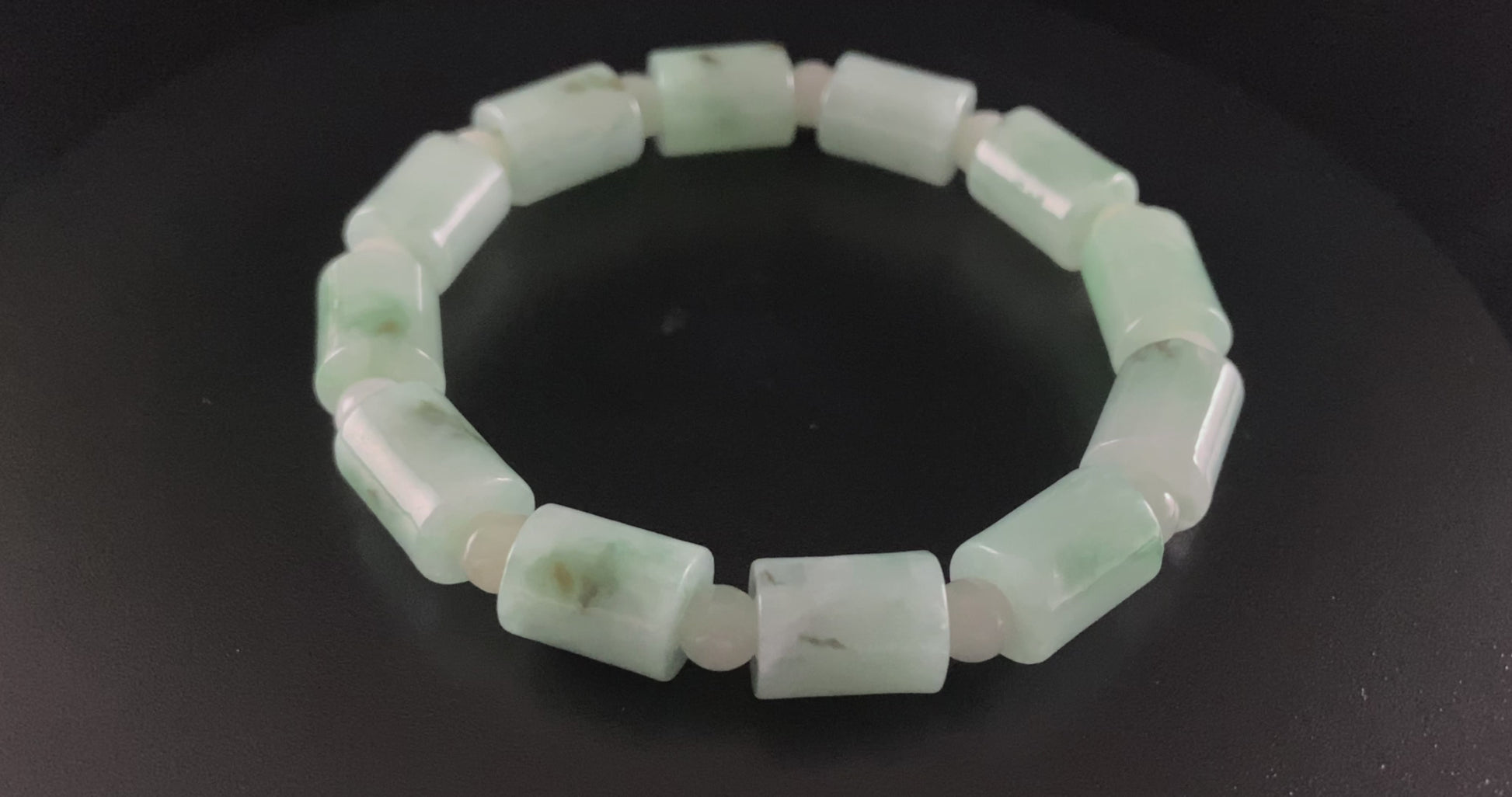 A mint green barrel beads bracelet.