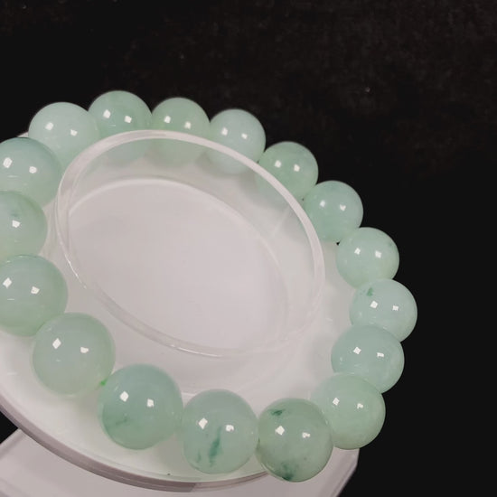 A translucent green with forest fleck  jadeite beads bracelet.