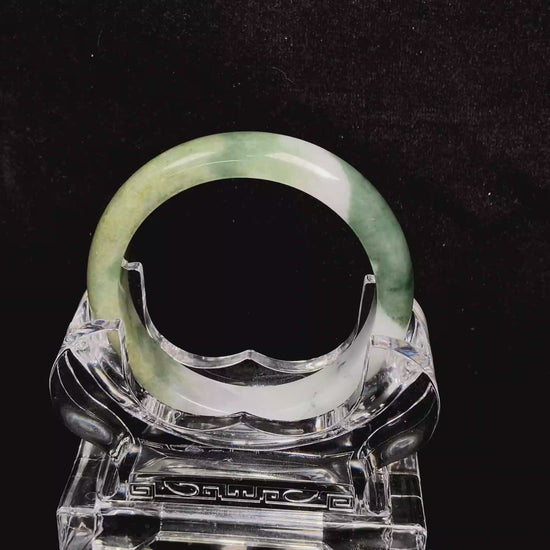 A verdant gold silken white  jadeite bangle.