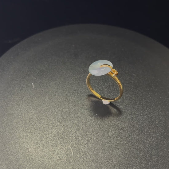 A green frost peace button jadeite ring.