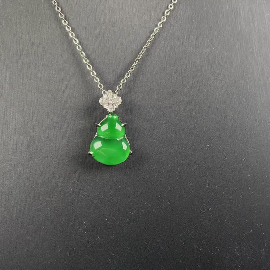 A diamond floral green hulu jadeite pendant.