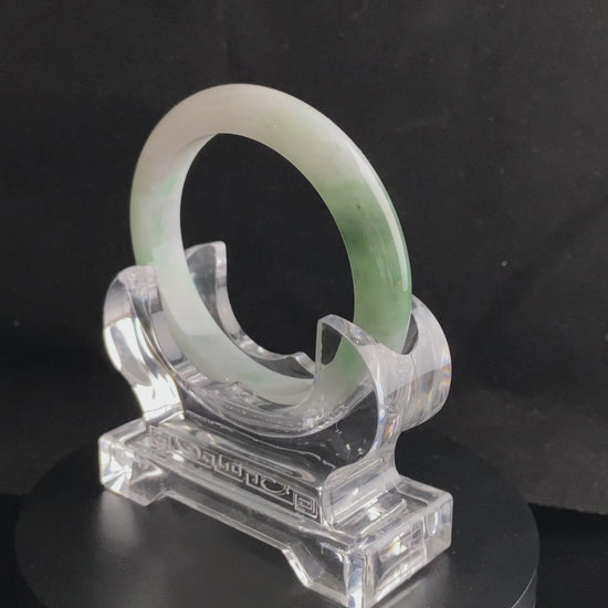 A cloud white and floating green jadeite bangle.