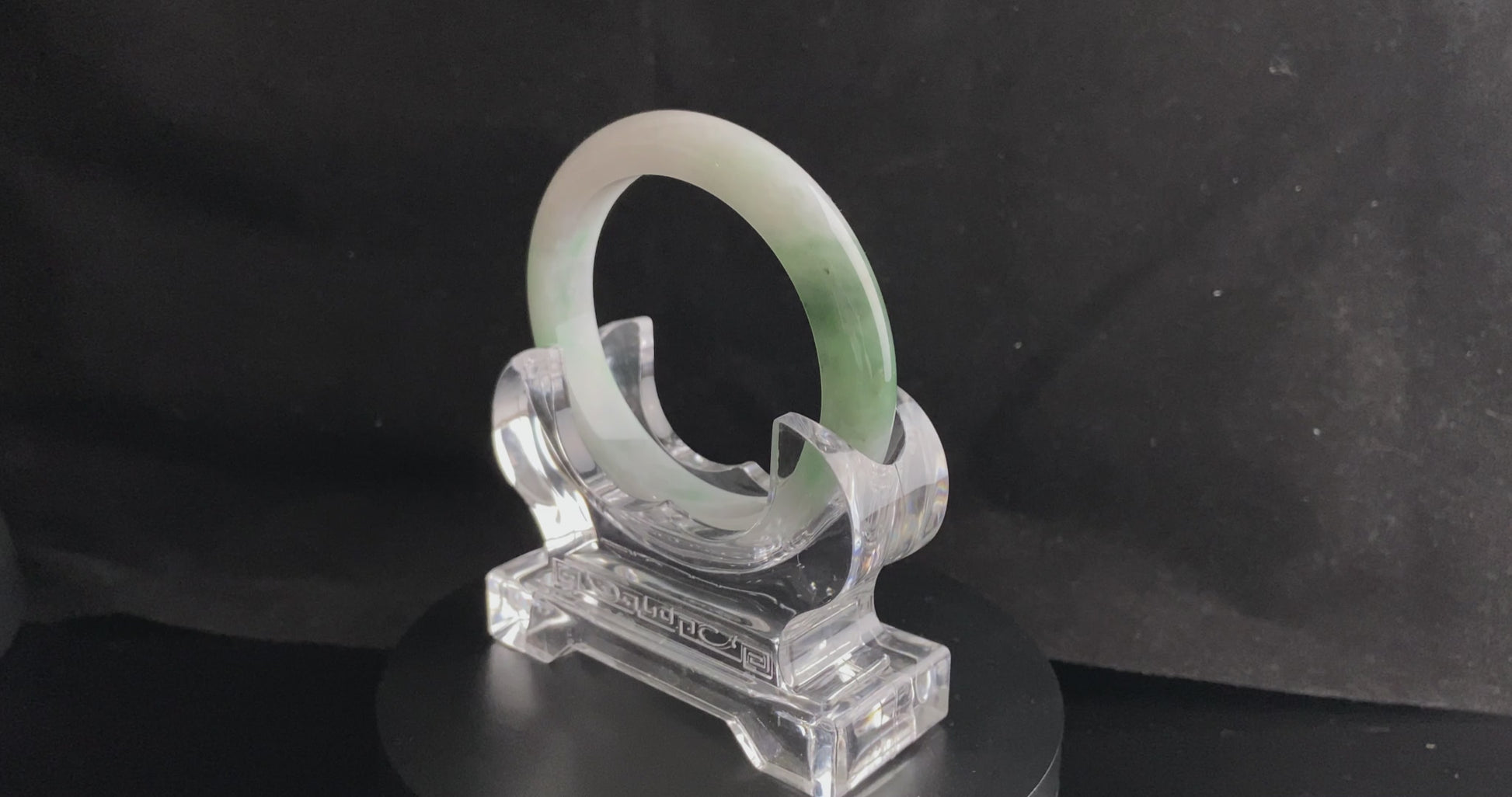 A cloud white and floating green jadeite bangle.