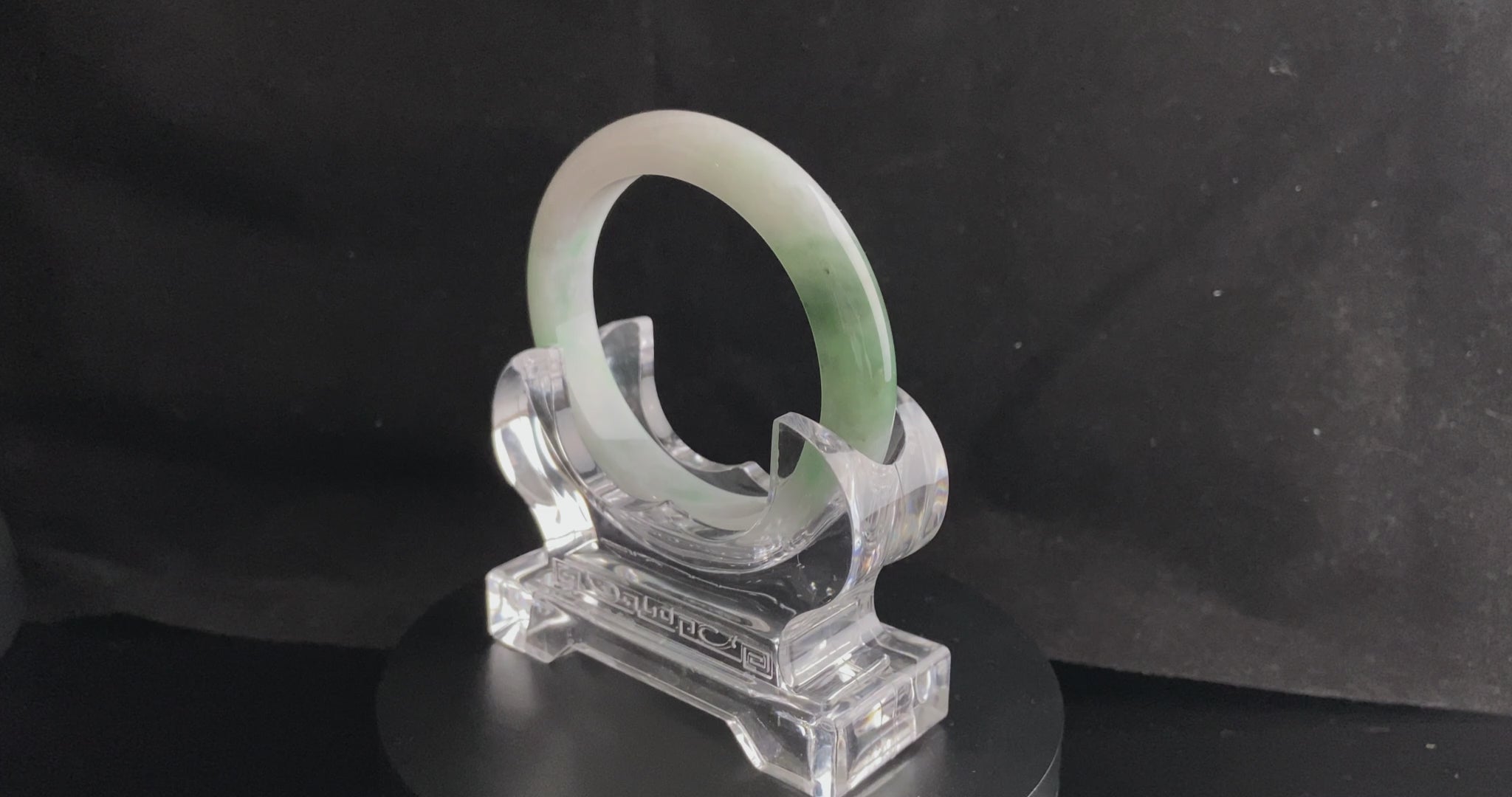 A cloud white and floating green jadeite bangle.