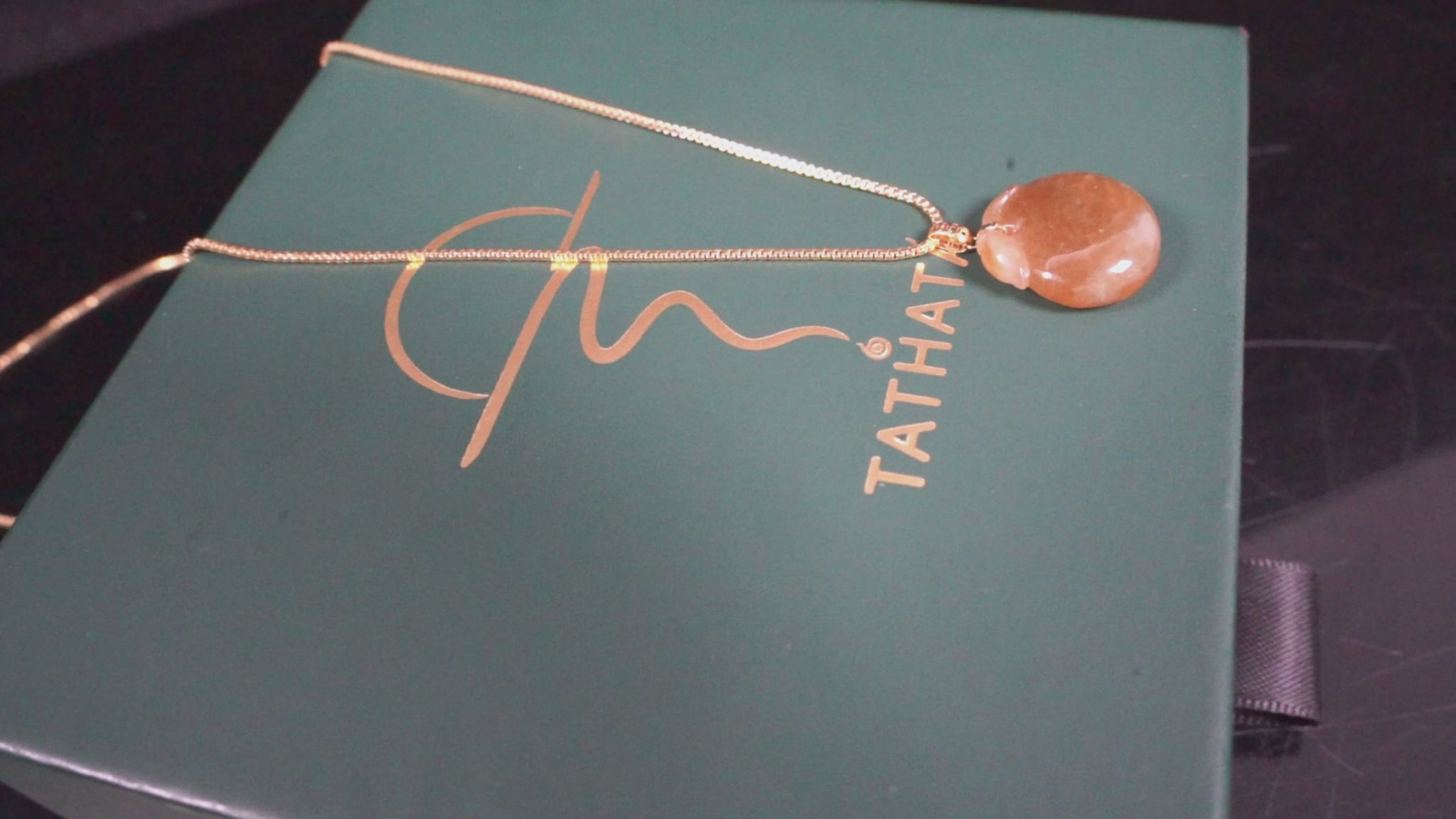 A warm amber-glazed apple Jadeite Pendant.