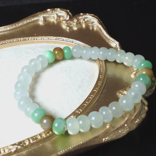 A glacial ice with green and amber accents jadeite beads bracelet.