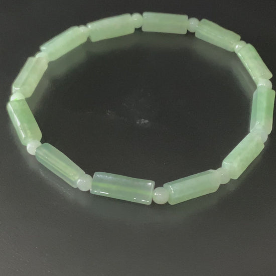 A mist green column jadeite beads bracelet.