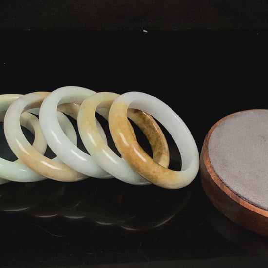 A golden dust sprinkled gently jadeite bangle.