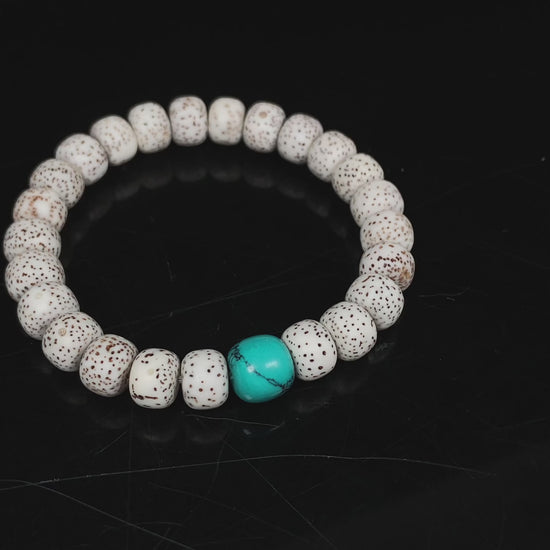 A crimson specks on cream star and moon bodhi beaded bracelet.