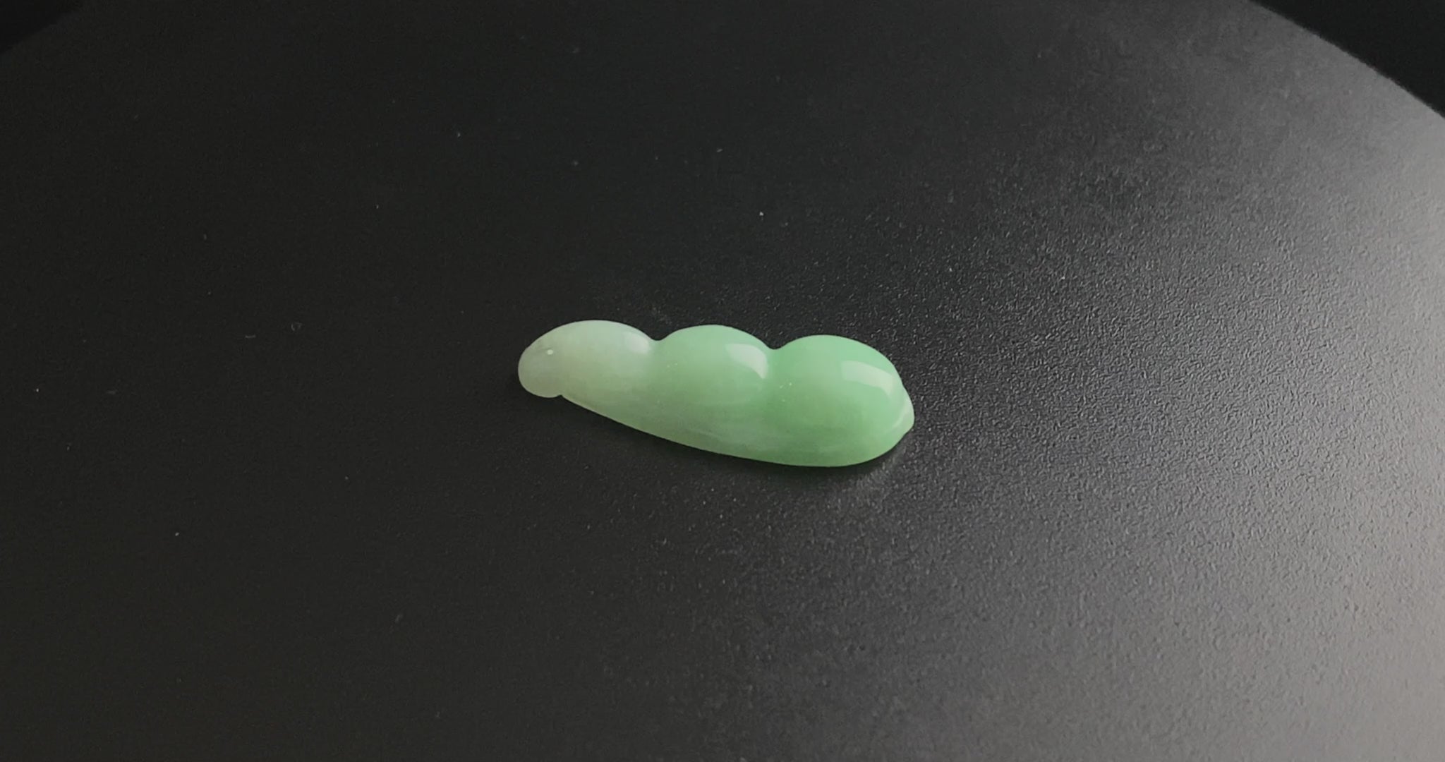 A pale green fortune pod loose jadeite.